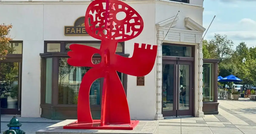 Victor Ekpuk Poses With His Sculpture "The Dance" on 14th and R St. DC. Photo by: Eugene O. Smith, Jr. 