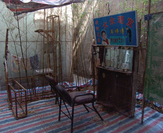 An open-air barber shop surrounded by bamboos