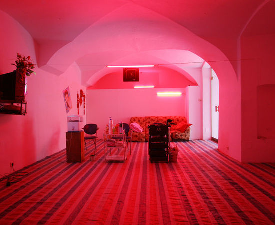 A barber shop is relocated into a room with pinkish neon lights in 2006