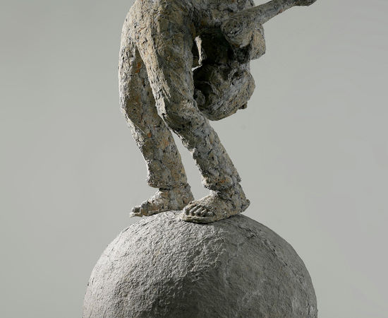 A body bends his body and stands on a ball. 