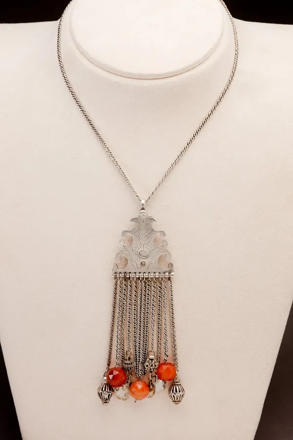 Silver incised pendant on long chain