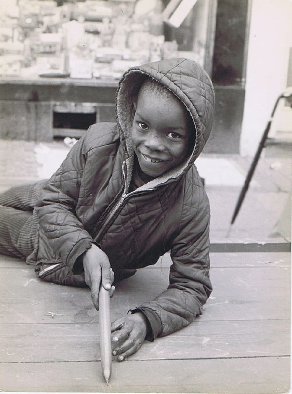 Charlie Phillips, Boy with candle, Tavistock Square, Notting Hill, 1969