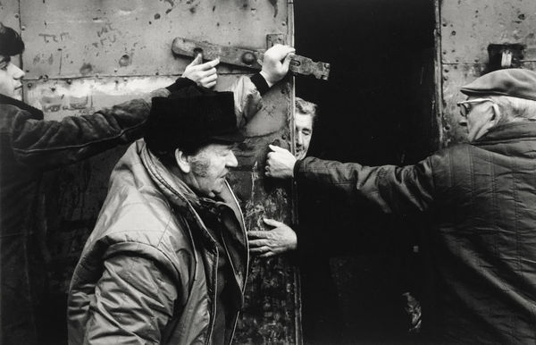 Markéta Luskačová, Photographs from Spitalfields (Men helping Mr Burns to close his warehouse), 1975