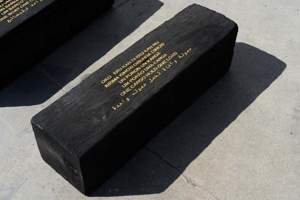 Grada Kilomba Untitled Poem (one cargo hold, one load), 2022 Charcoal log with gold leaf engraving 11 3/4 x 11 3/4 x 35 3/8 inches 30 x 30 x 90 cm