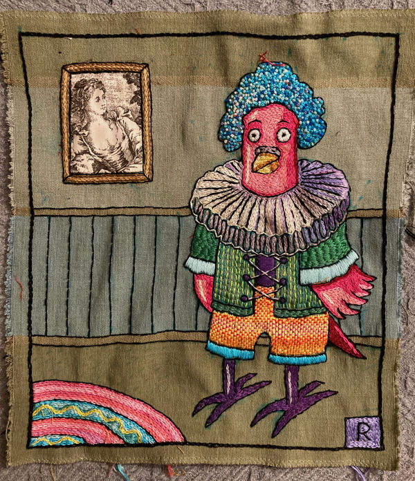 embroidered bird in elaborate outfit stands in a room with an image of woman in a frame on the wall