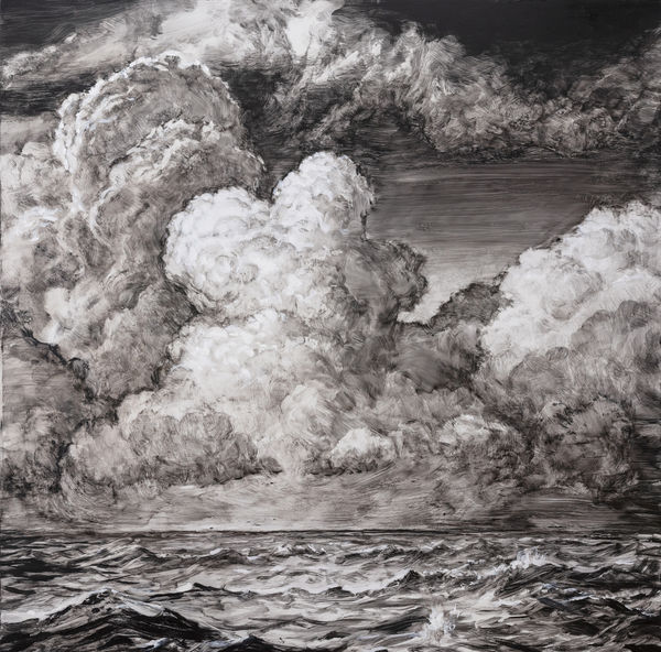 black and white image of ocean waves and dramatic clouds