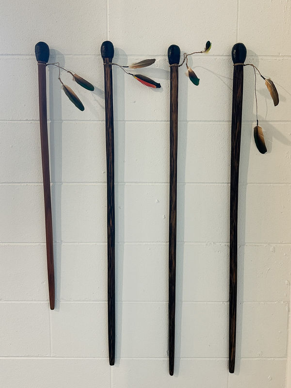 Bernard Singleton ’DAGIL’ (Walking Stick), 2025 Black Palm/ironwood, Red Leaf fig string, resin, feathers 1: 85 cm, 2-4: 105 cm (approx.)