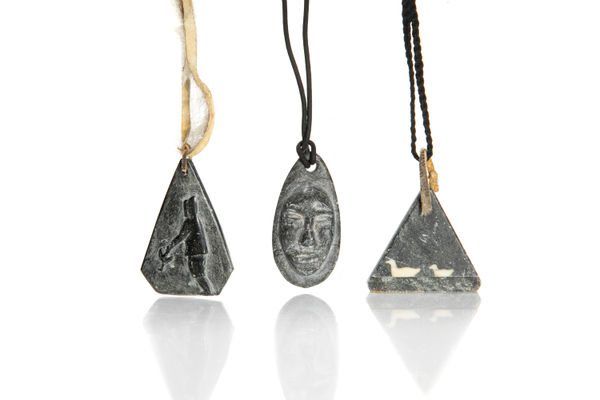 Lot 78 JAMASIE MIKE (1928-) PANNIRTUQ (PANGNIRTUNG), MOSES AUPALUKTIK (1924-1983) PUVIRNITUQ (POVUNGNITUK), and JOSEPHEE KILABUK (1934-) PANNIRTUQ (PANGNIRTUNG) Three Pendants , mid-late 1960s & 1968 stone, hide, string, and antler inlay, 2.25 x 1.5 x 0.25 in (5.7 x 3.8 x 0.6 cm) and smaller ESTIMATE: $300 — $500 PRICE REALIZED: $312.00