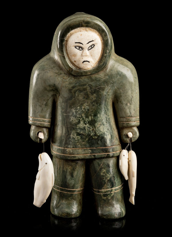 Lot 6 UNIDENTIFIED INUIT ARTIST, Probably INUKJUAK (PORT HARRISON) OR SANIKILUAQ (BELCHER ISLANDS) Fisherman with Catch, c. early 1950s stone, bone, ivory, soap, string, and black pigment, 9.75 x 5.5 x 3 in (24.8 x 14 x 7.6 cm) ESTIMATE: $5,000 — $8,000 PRICE REALIZED: $5,124.00