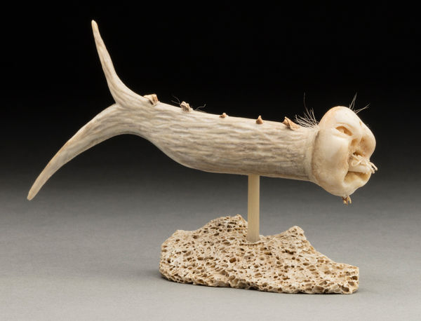 Lot 103 NICK SIKKUARK (1943-2013) KUGAARUK (PELLY BAY) / UQSUQTUUQ (GJOA HAVEN) Fish Shaman, 1990s antler, bone, muskox horn, fur, and waxed string, 3 x 5.75 x 1.25 in (7.6 x 14.6 x 3.2 cm) ESTIMATE: $600 — $900 PRICE REALIZED: $1,920.00