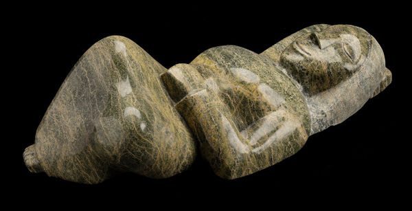 Lot 130 OVILOO TUNNILLIE, R.C.A. (1949-2014) KINNGAIT (CAPE DORSET) Resting Woman, 2000 stone, 6 x 19.5 x 7.5 in (15.2 x 49.5 x 19.1 cm) ESTIMATE: $8,000 — $12,000 PRICE REALIZED: $14,400.00