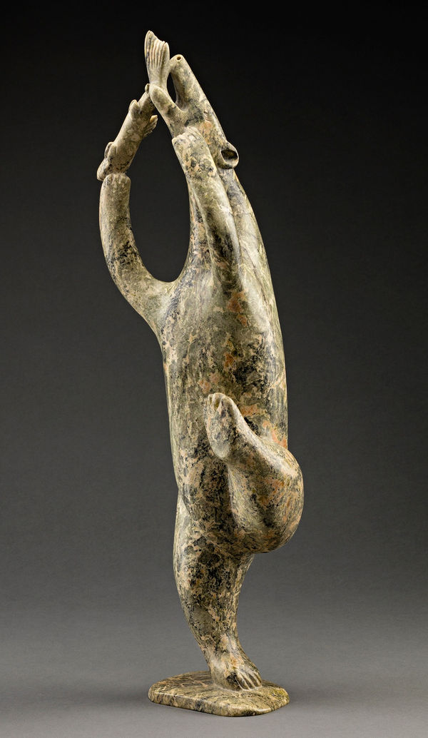 Lot 107 OSUITOK IPEELEE, R.C.A. (1922 or 1923-2005) KINNGAIT (CAPE DORSET Bear and Fish, early-mid 1980s stone, 21 x 6 x 5 in (53.3 x 15.2 x 12.7 cm) ESTIMATE: $15,000 ⁠— $25,000 PRICE REALIZED: $13,200.00
