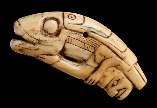 Lot 29 UNIDENTIFIED TLINGIT ARTIST Amulet, c. 1840-60 probably sperm whale tooth, 1.25 x 3 x 0.5 in (3.2 x 7.6 x 1.3 cm) ESTIMATE: $6,000 — $9,000 PRICE REALIZED: $7,800.00
