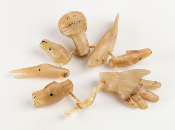 Lot 147 BARNABUS ARNASUNGAAQ (1924-2017) QAMANI'TUAQ (BAKER LAKE) Shaman's Amulets, 1967 muskox horn, inlaid caribou hoof, and sinew, dimensions variable, overall: 0.75 x 4.5 x 4.5 in (1.9 x 11.4 x 11.4 cm) ESTIMATE: $1,500 — $2,500 PRICE REALIZED: $11,400.00
