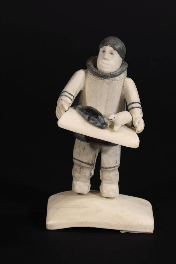 ROMEO EEKERKIK (1923-1983) ARVIAT (ESKIMO POINT) The Carver, 1981 antler, stone, and sinew, 5.75 x 3.25 x 3 in (14.6 x 8.3 x 7.6 cm)
