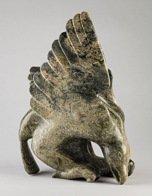 Lot 137 OVILOO TUNNILLIE, R.C.A. (1949-2014) KINNGAIT (CAPE DORSET) Alighting Hawk, late 1980s stone, 19.5 x 13.5 x 6.5 in (49.5 x 34.3 x 16.5 cm) ESTIMATE: $6,000 — $9,000 PRICE REALIZED: $7,200.00