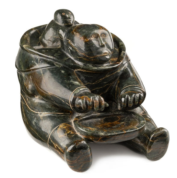 Lot 34 ELIJASSIAPIK (1912-1972) INUKJUAK (PORT HARRISON) Seated Mother and Child with Platter, c. 1953-55 stone and soap inlay, 5 x 5.75 x 4.75 in (12.7 x 14.6 x 12.1 cm) ESTIMATE: $20,000 — $30,000 PRICE REALIZED: $23,180.00