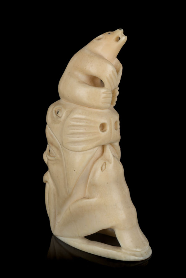 Lot 23 HENRY NAPARTUK (1932-1985) KUUJJUARAPIK (GREAT WHALE RIVER) Totemtic Composition with Arctic Animals, mid-late 1960s tooth and black inlay, 3.75 x 1 x 1.5 in (9.5 x 2.5 x 3.8 cm) ESTIMATE: $400— $600 PRICE REALIZED: $463.60