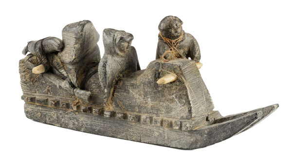 Lot 93 JOE TALIRUNILI (1893-1976) PUVIRNITUQ (POVUNGNITUK) Family on a Qamutiq (Sled), c. 1967-8 stone, wood, ivory, and string, 3.5 x 8.5 x 2.75 in (8.9 x 21.6 x 7 cm) ESTIMATE: $9,000 — $12,000 Price Realized: $9,600