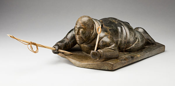 Lot 74 ISAH QUMALU SIVUARAPI (1925-1979) PUVIRNITUQ (POVUNGNITUK) Crawling Hunter with Harpoon and Line, late 1950s stone, ivory, and sealskin, 16.5 x 9.75 x 7 in (41.9 x 24.8 x 17.8 cm) ESTIMATE: $4,000 — $6,000 PRICE REALIZED: $9,000.00