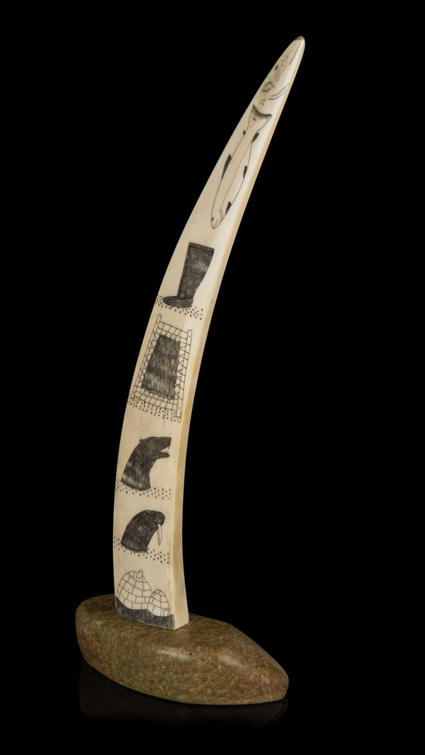 Lot 18 Possibly JOE ARLOOKTOO (1939-) KIMMIRUT (LAKE HARBOUR) Incised Tusk with Arctic Motifs, c. 1970 ivory, stone, and black ink, 12.75 x 4.75 x 3 in (32.4 x 12.1 x 7.6 cm) ESTIMATE: $500 — $800 PRICE REALIZED: $414.80