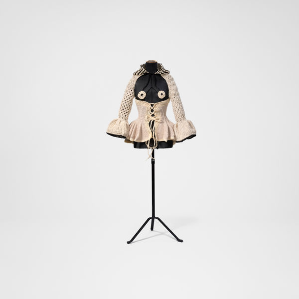 Svart byst, vit stickad korsett med långa ärmar.