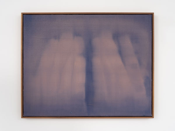 A deep indigo background is softly covered with lighter, pinkish strokes that are vertically oriented. The image abstractly resembles hands covering a face.