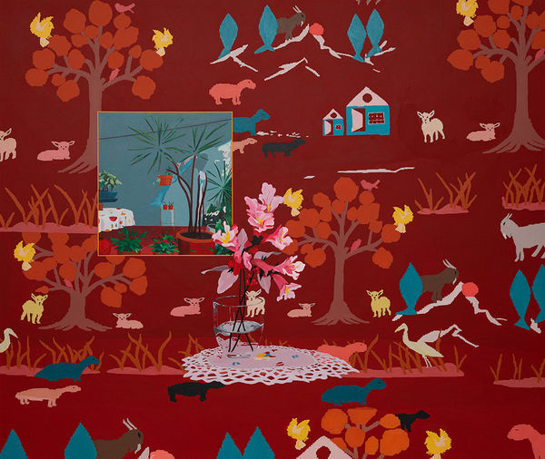 Painting of red and pink flowers in a vase on a white dolly. The table the flowers are resting on and the wall behind it blend in together with matching wallpaper of fall trees and blue houses.