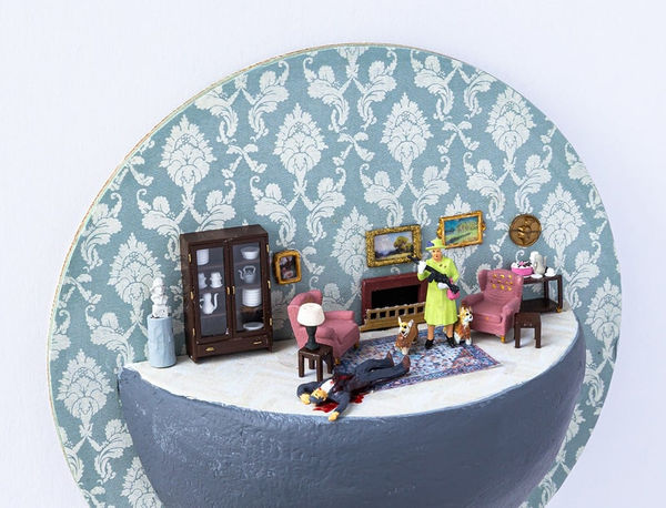 miniature diorama by Abigail Goldman of the Queen of England holding a rifle and standing next to a man bleeding on the floor