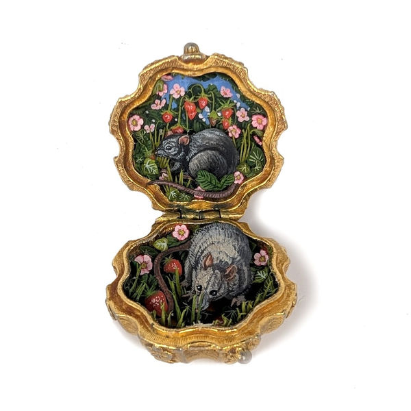 vintage compact with detailed paper cutouts of grassy flowers and two rates