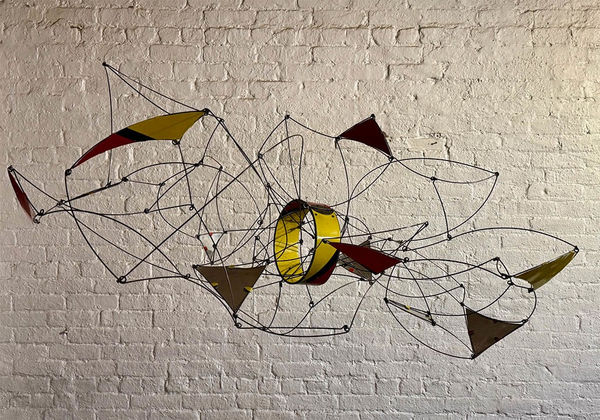 Wire hanging mobile sculpture with colorful panels in red, blue, yellow