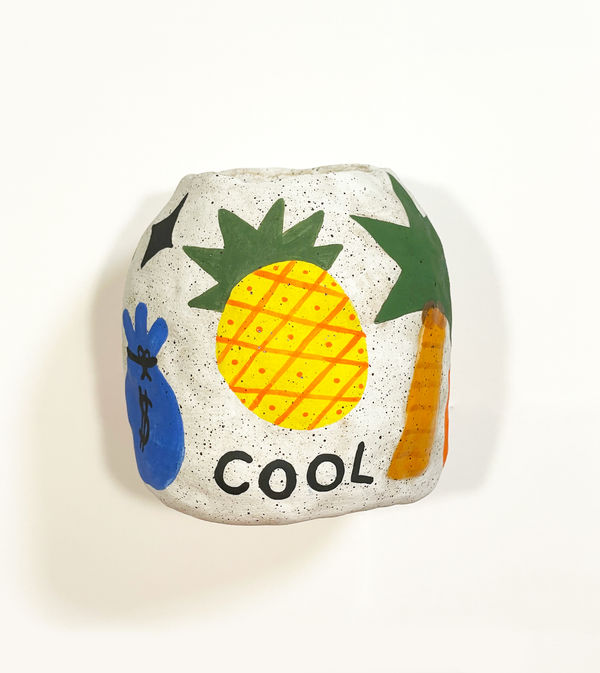 Jackie Brown's sculpture with of a vase with fruit on it