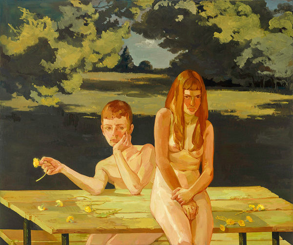 nude girl seated on top of a picnic table next two another nude girl sitting on an accompanying bench