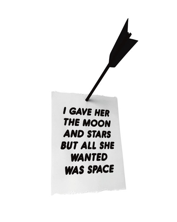 Piece of paper with the words "I GAVE HER THE MOON AND STARS BUT ALL SHE WANTED WAS SPACE" and a black arrow going through it