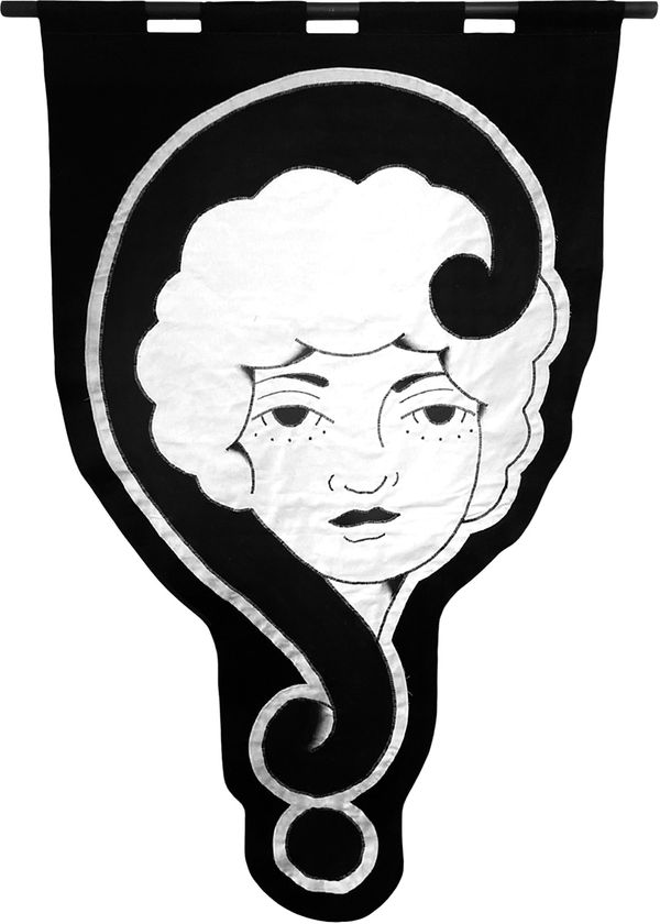 embroidered black and white banner of a woman's head with curve design to her left