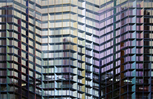 Abstract urban landscape with several blurry and colorful high rise buildings A multi-colored grid of alternating thin and thick horizontal and vertical lines form the illusion of foreground scaffolding