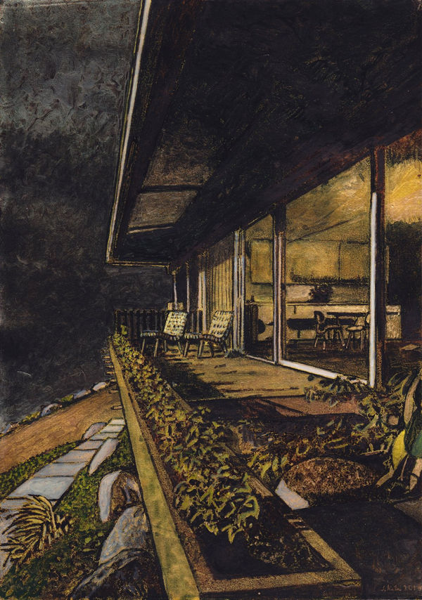 Glass walls of house reveal kitchen interior. In front, awning hangs over two lawn chairs and neat landscaping beneath dark night sky.