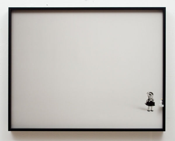 Duraflex print of a black and white digital photograph of a small chubby little girl figurine with a large bow in her hair and a dark dress. The figurine is situated at the lower right of the photograph which is framed. Next to the figure and mounted on the side frame is a tiny black and white penguin. The penguin and the doll appear to be side eyeing each other