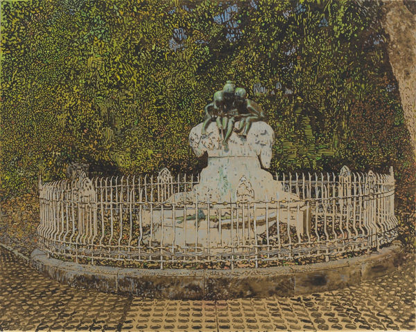 White fence enclosure encircles sculpture of bronze figures seated on white stone mound. Enclosure sits on cobblestone sidewalk in front of dense foliage.