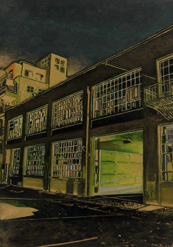 In sepia tones, industrial building with large multi-colored glass windows and open garage is deserted underneath the night sky. Other buildings peek out from behind.