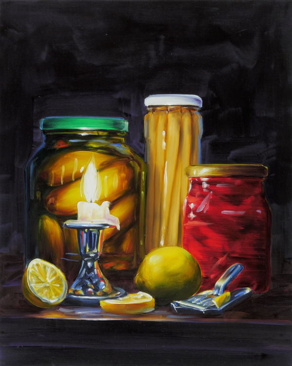 Still life of a lit candle, three jars of different types of pickles, and lemons (one whole, one halved, and one single slice).