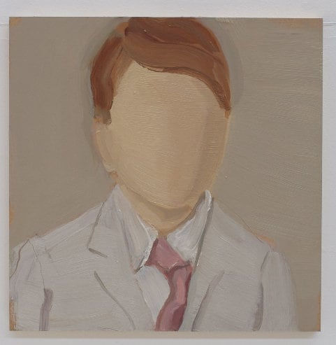 Portrait of faceless boy wearing gray coat and pink tie.