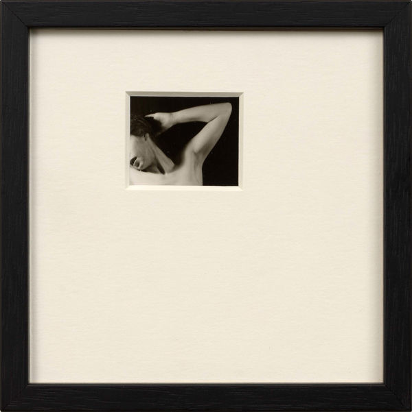 Framed artwork by Sissi Farassat featuring a black-and-white photo of a nude figure in a minimal composition with wide matting.