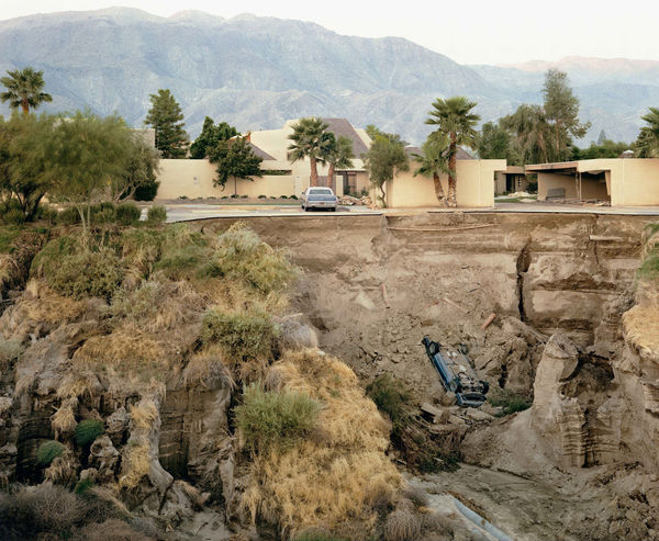 Joel Sternfeld, car in ravine below houses and hills