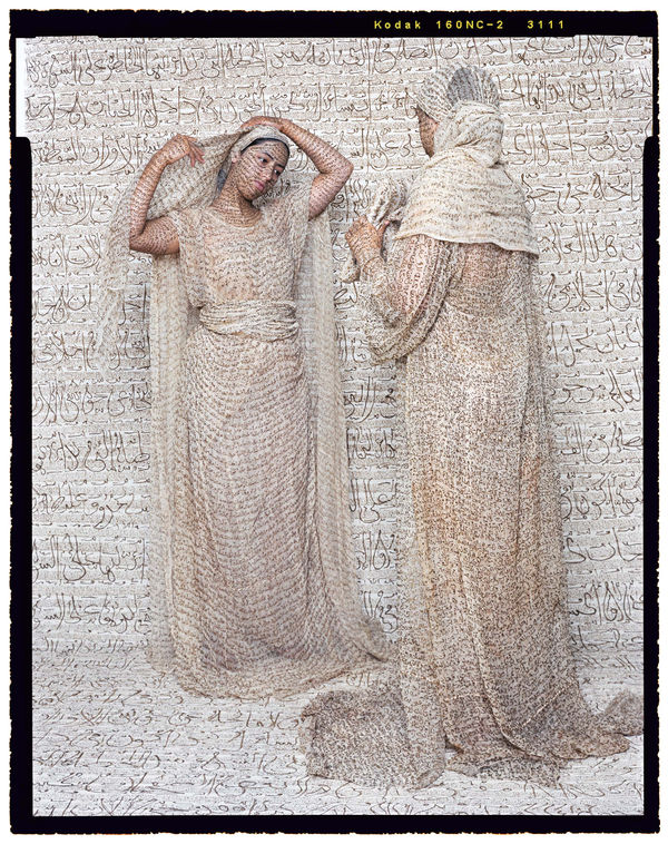 Lalla Essaydi, Les Femmes du Maroc: Light of the Harem, Two women facing each other wearing clothing inscribed with henna calligraphy