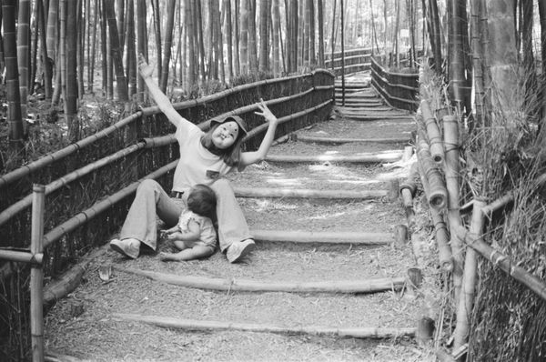 Hideoki, Mary Sitting on Bamboo Steps with Playful Arms, Japan, 1973