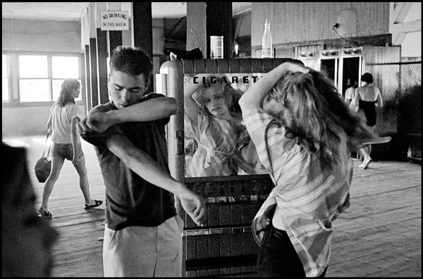 Bruce Davidson, Brooklyn Gang (Girl Fixing Hair in Cigarette Machine Mirror), 1959