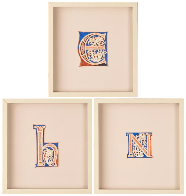 Three decorative medieval illuminated manuscript letters “E” "H", "N" in red, blue, and cream, featuring intricate floral and vine-like patterns inside the letterform, centered on a plain parchment background within a wide margin. From an Atlantic Bible, Tuscany, Italy, 12th century.