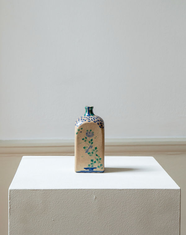 Kyō-yaki, 18th century - early 19th century A saké flask with autumn flowers on each of the four sides. Glazed ceramic. Kyoto, Japan. 18 cm (h) Provenance: Yasahiro Yoshida, Kyoto Collection: John Kasmin