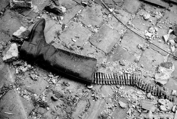 Lee Miller Debris on pavement outside, [Boot and ammunition], St Malo, France, 1944 Platinum Palladium print. From the edition of 10. Printed for the Lee Miller Archives by 31 Studio. Image size: 20.1 x 30 cm (7 7/8 x 11 3/4 in) Paper size: 48 x 38 cm (18 7/8 x 15 in)